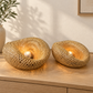 Two handwoven bamboo halo lamp shades illuminated in a natural interior